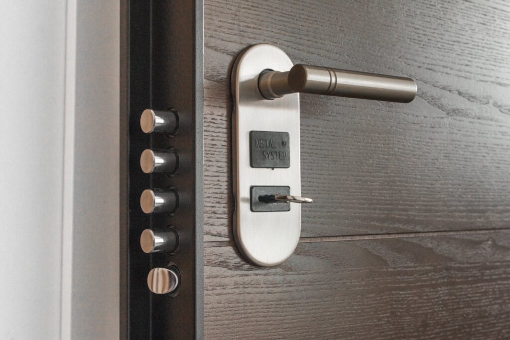 pexels photo 279810 Metal door handle and lock system with key inserted, showcasing security features.
